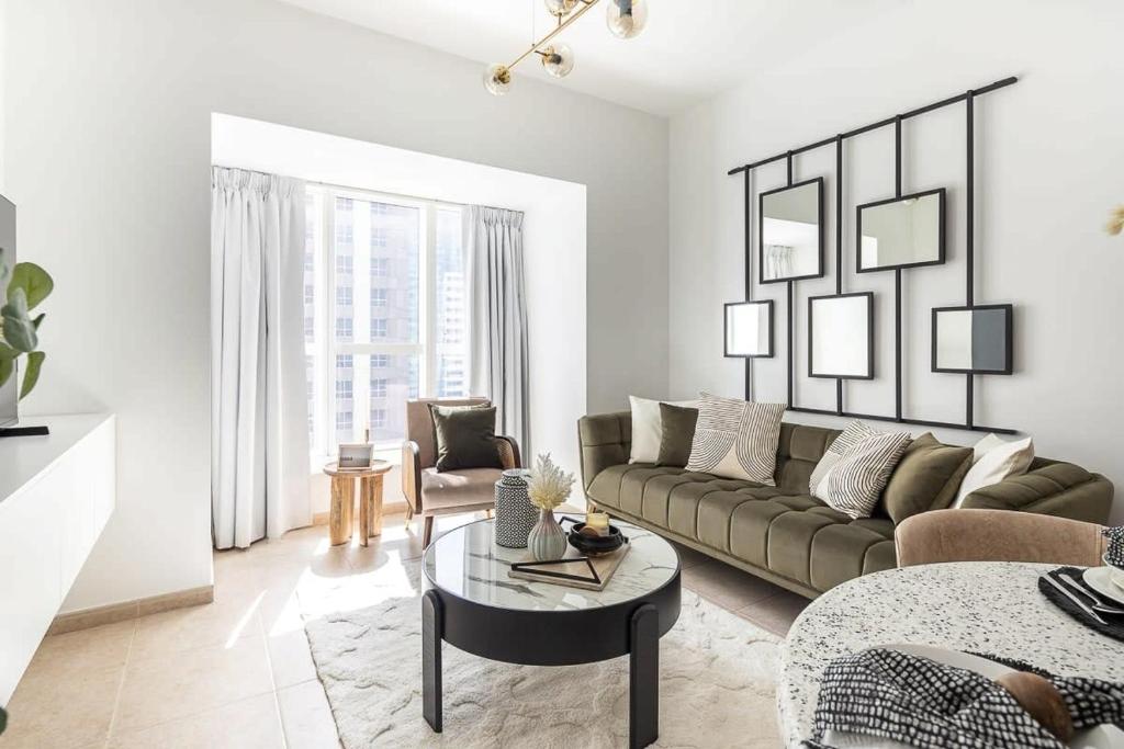 a living room with a couch and a table at Frank Porter - Elite Residence in Dubai