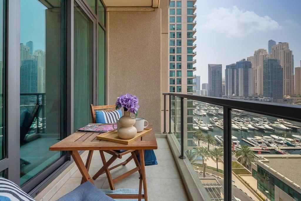 a balcony with a table and a view of a city at Frank Porter - Al Majara in Dubai