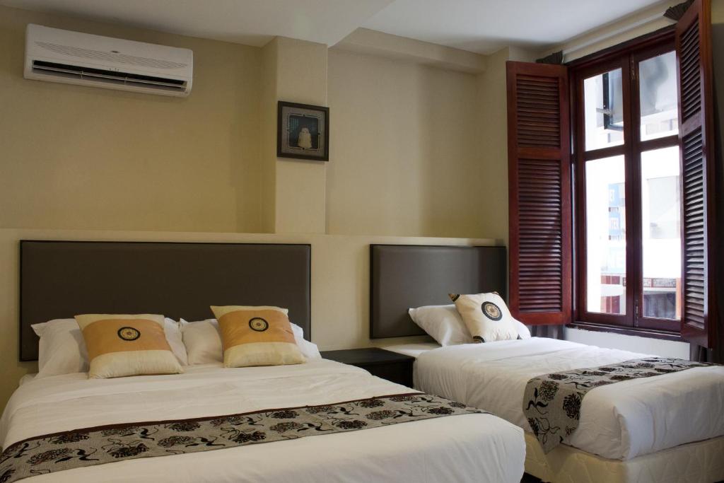 Postel nebo postele na pokoji v ubytování SohoTown Hotel