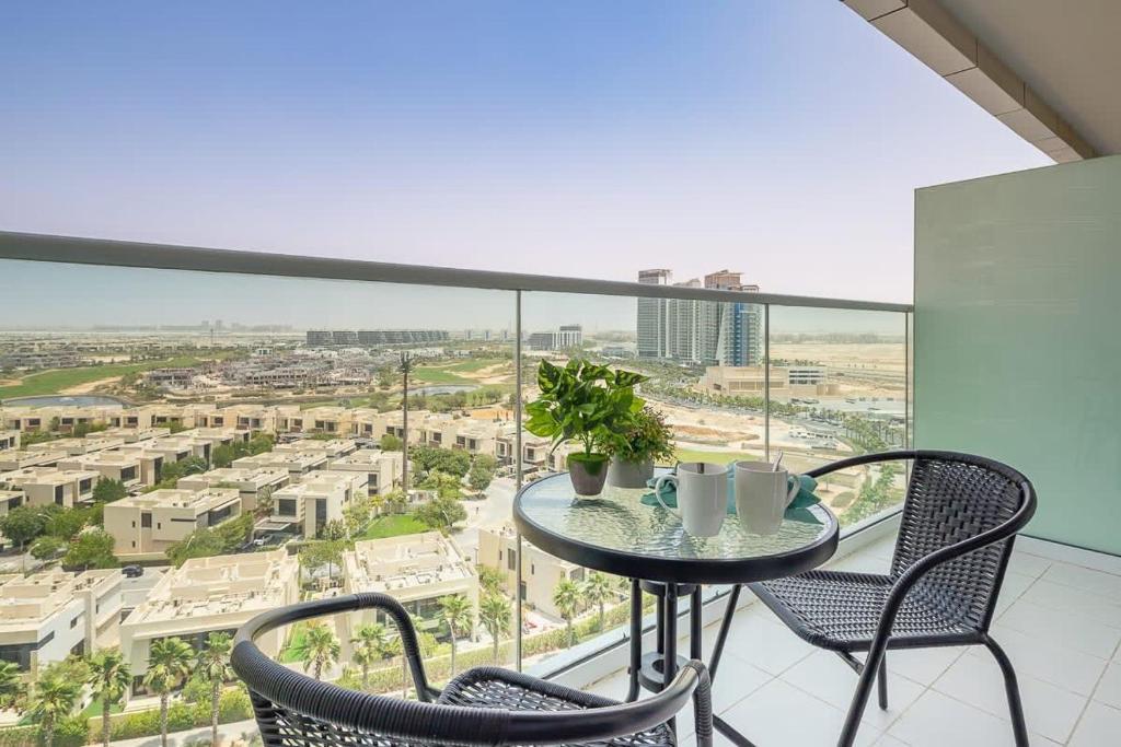 a table and chairs on a balcony with a view of the city at Frank Porter - Carson A in Dubai Marina