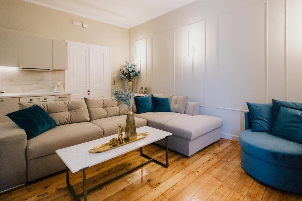 a living room with a couch and a table at Mantzarou Suites by Corfu Collection in Ágios Rókkos