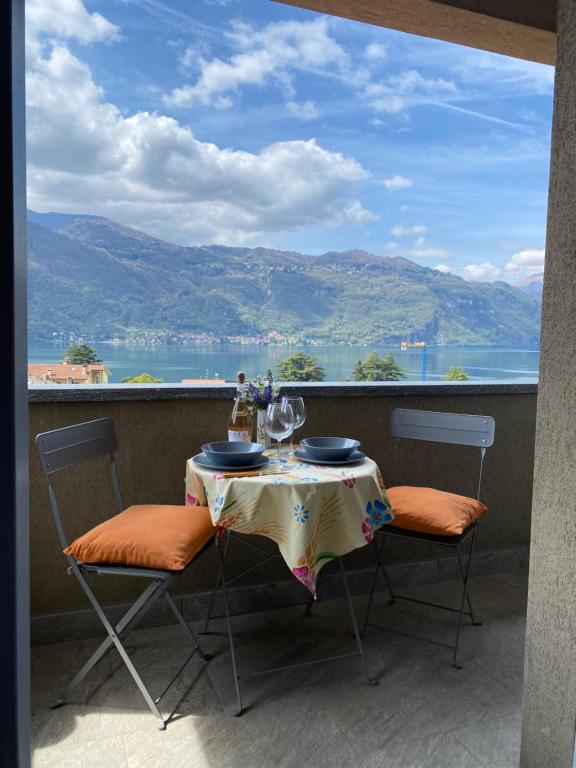 a table with two chairs and a view of the water at 2 Cuori al Lago - Appartamento in villetta singola in Mandello del Lario