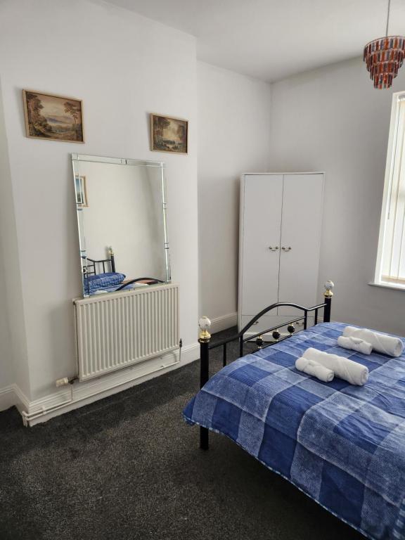 a bedroom with a bed with two towels on it at House in Newton-le-Willows in Newton-le-Willows