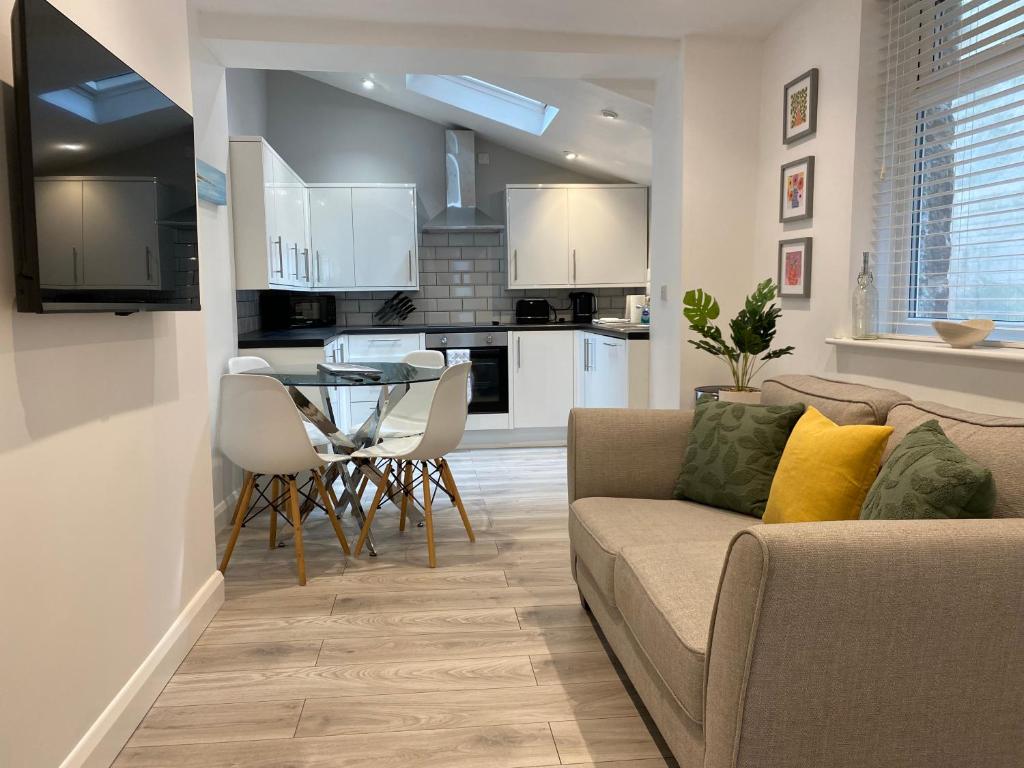 a living room with a couch and a table at Seaside Apartments in the Centre of Morecambe in Morecambe