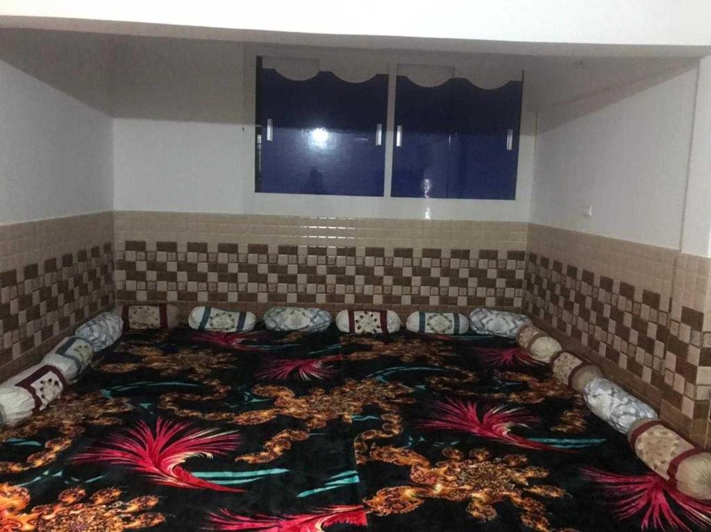 a room with a large rug on the floor at POP Ain Ul Noor Homestay in Thanna Mandi