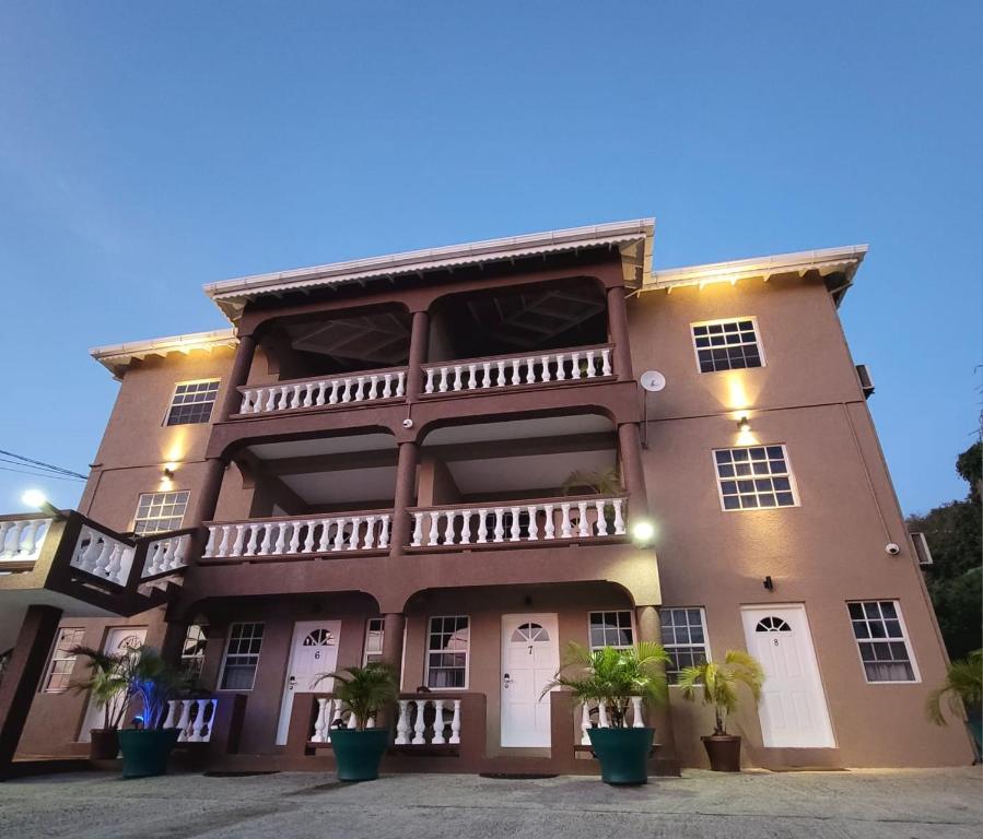 a building with potted plants in front of it at Silver View Apartments in Saint Georgeʼs