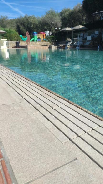 a swimming pool with blue water and people in the background at Campeggio Gianna Golfo dei Poeti in Lerici