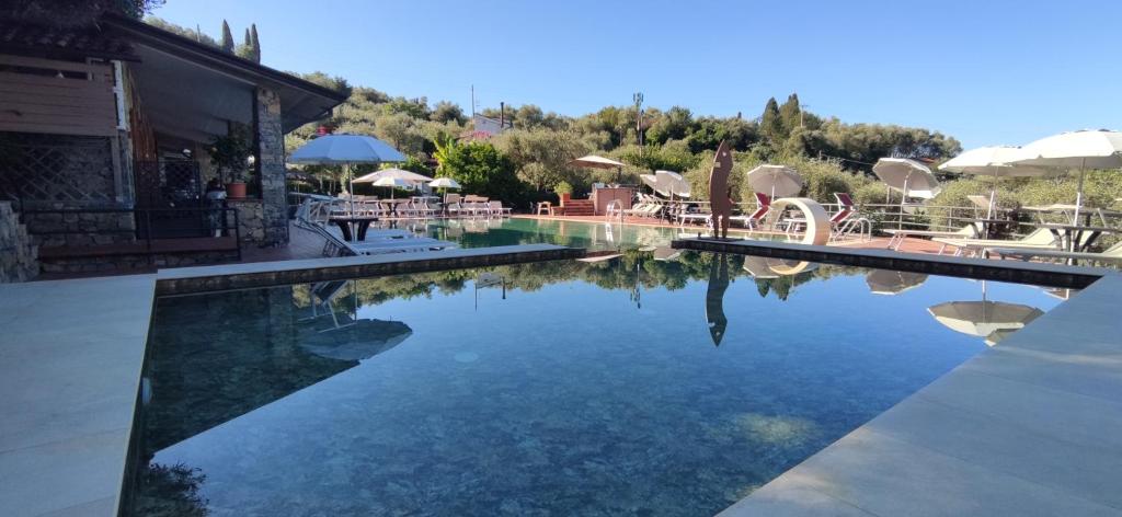 a pool of water with tables and umbrellas at Campeggio Gianna Golfo dei Poeti in Lerici