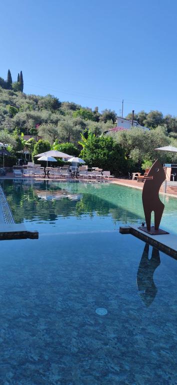 a statue of a bear sitting on the edge of a pool of water at Campeggio Gianna Golfo dei Poeti in Lerici