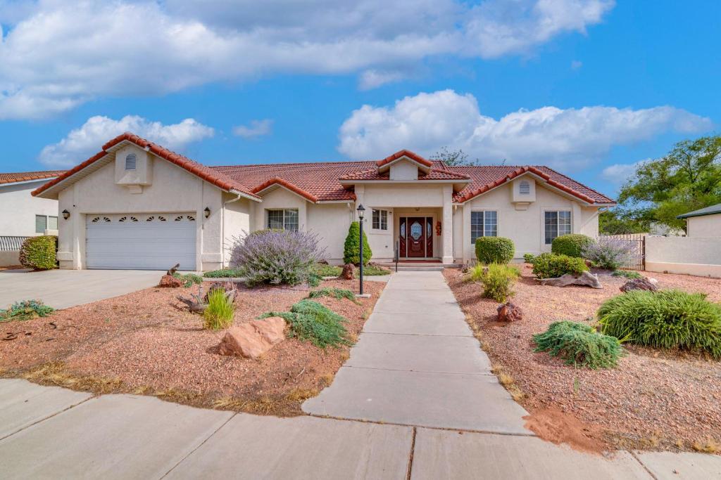 a house with a driveway in front of it at Page Home with Waterfall about 2 Mi to Lake Powell! in Page