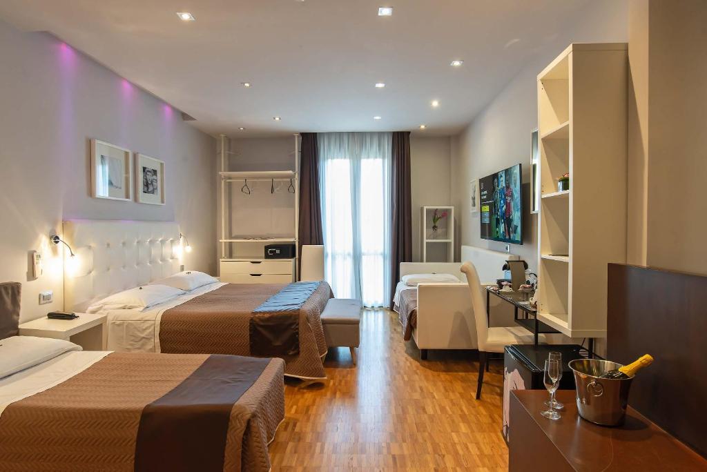 Postel nebo postele na pokoji v ubytování Hotel Orcagna