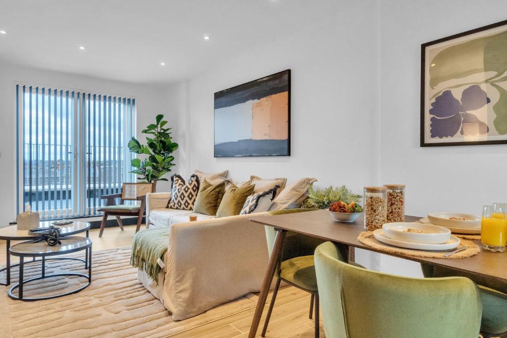 a living room with a couch and a table at homely- North London Penthouse Apartment Finchley in Finchley