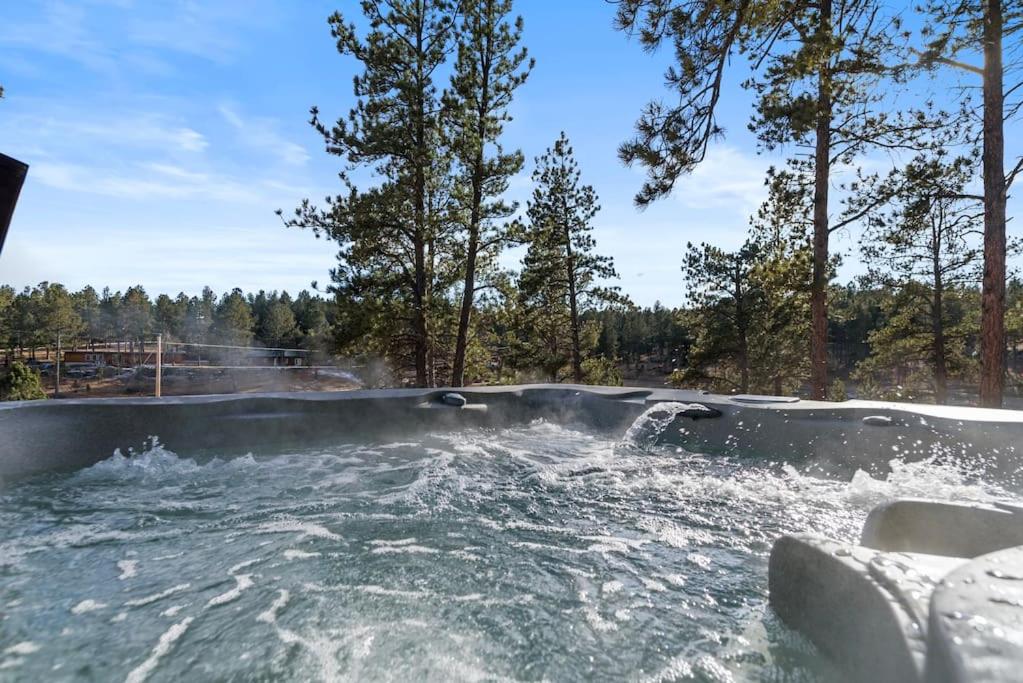 a hot tub with water in it with trees at Hottub Haven BHBungalows #9 in Custer