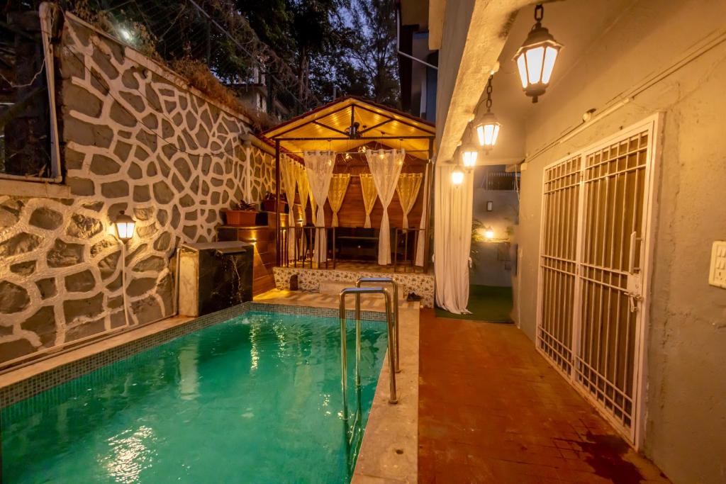 a swimming pool in the middle of a house at Lavender Heights in Lonavala