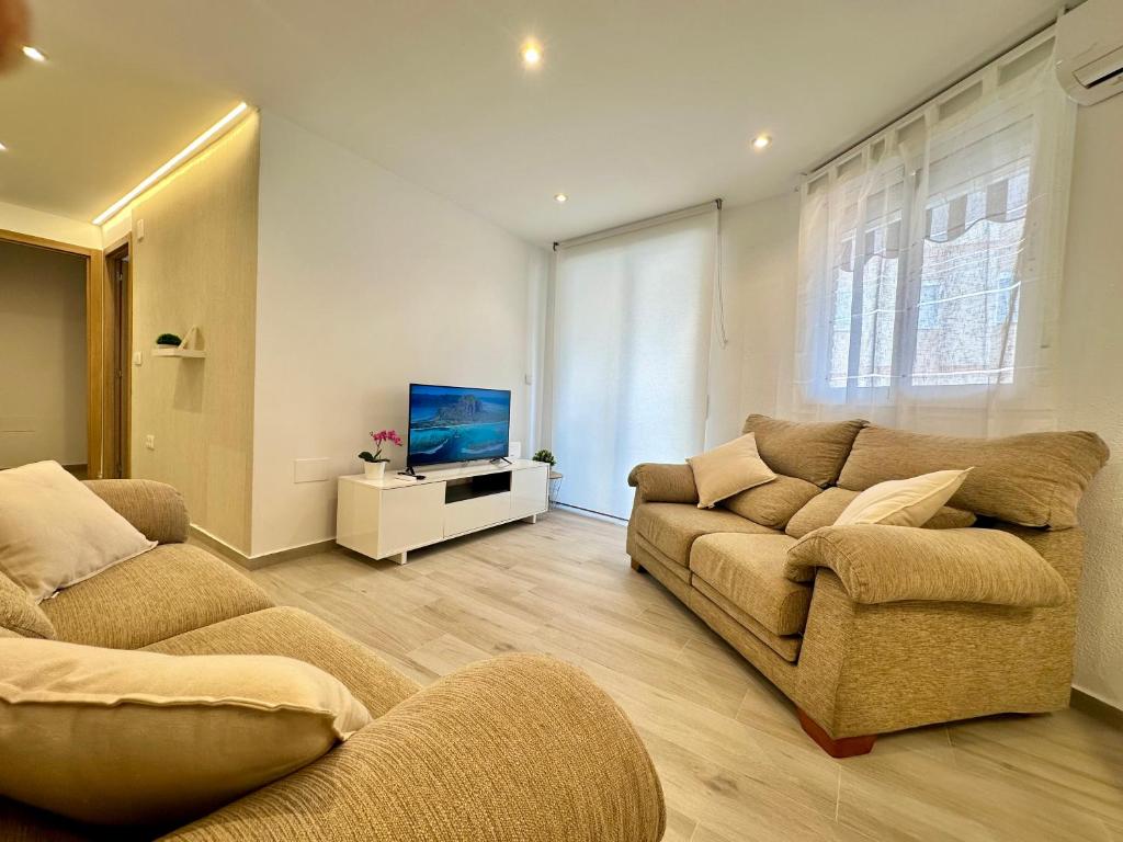 a living room with two couches and a flat screen tv at El Mirador De Casablanca in Alcantarilla