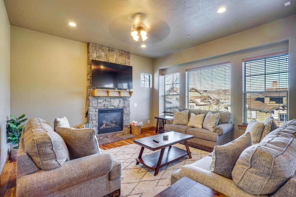 a living room with couches and a fireplace at Townhome with Outdoor Pool Access 6 Mi to Park City in Heber City