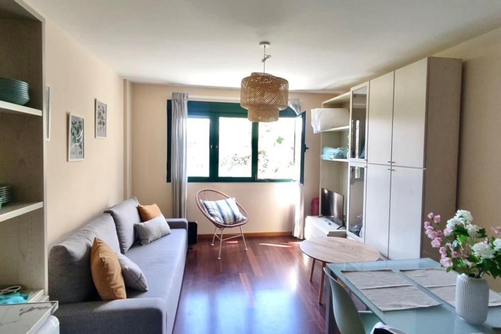 a living room with a couch and a table at O Pindo in O Pindo