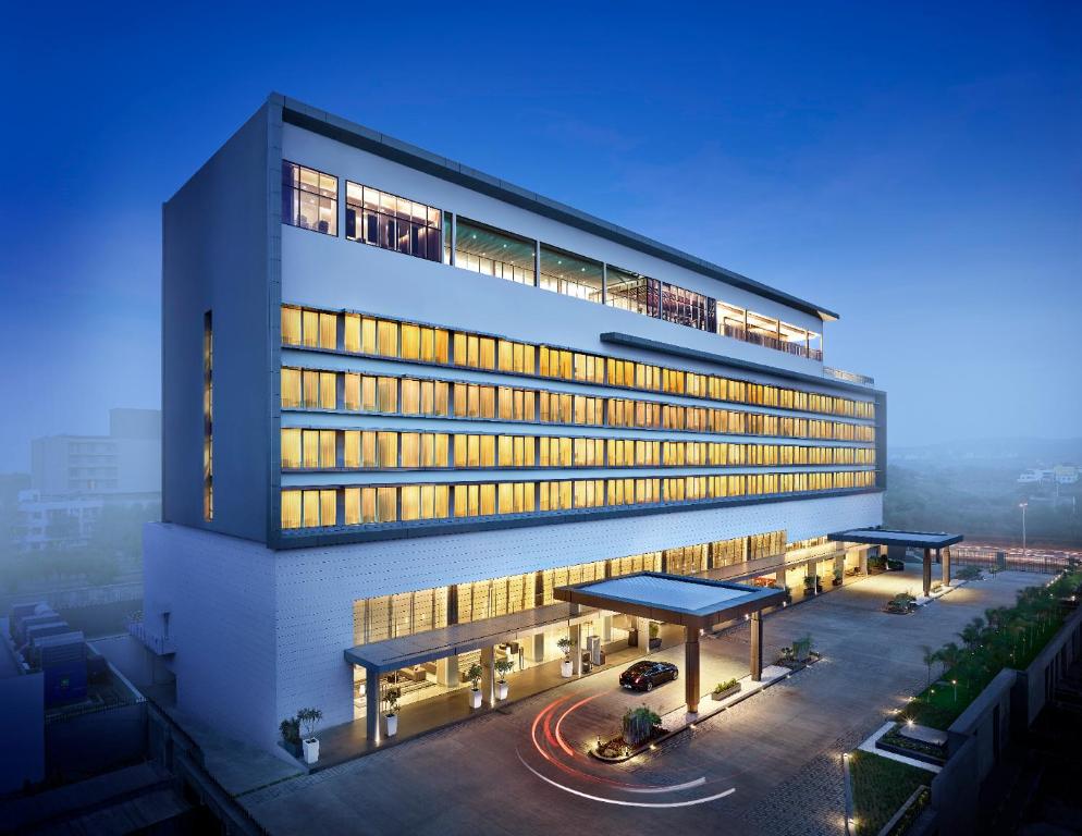 a large building with a parking lot in front of it at Vivanta Pune, Hinjawadi in Pune
