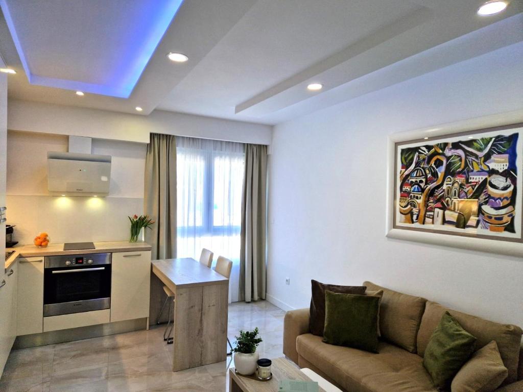a living room with a couch and a kitchen at Luxury apartment Galant 1 in Split