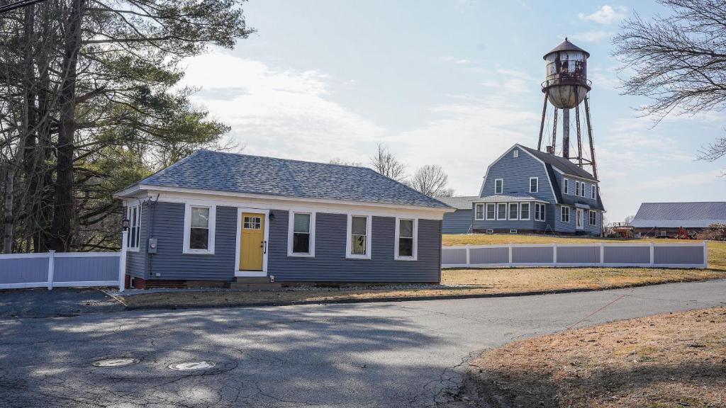 a small house with a lighthouse in the background at Old Mill Inn in Hatfield