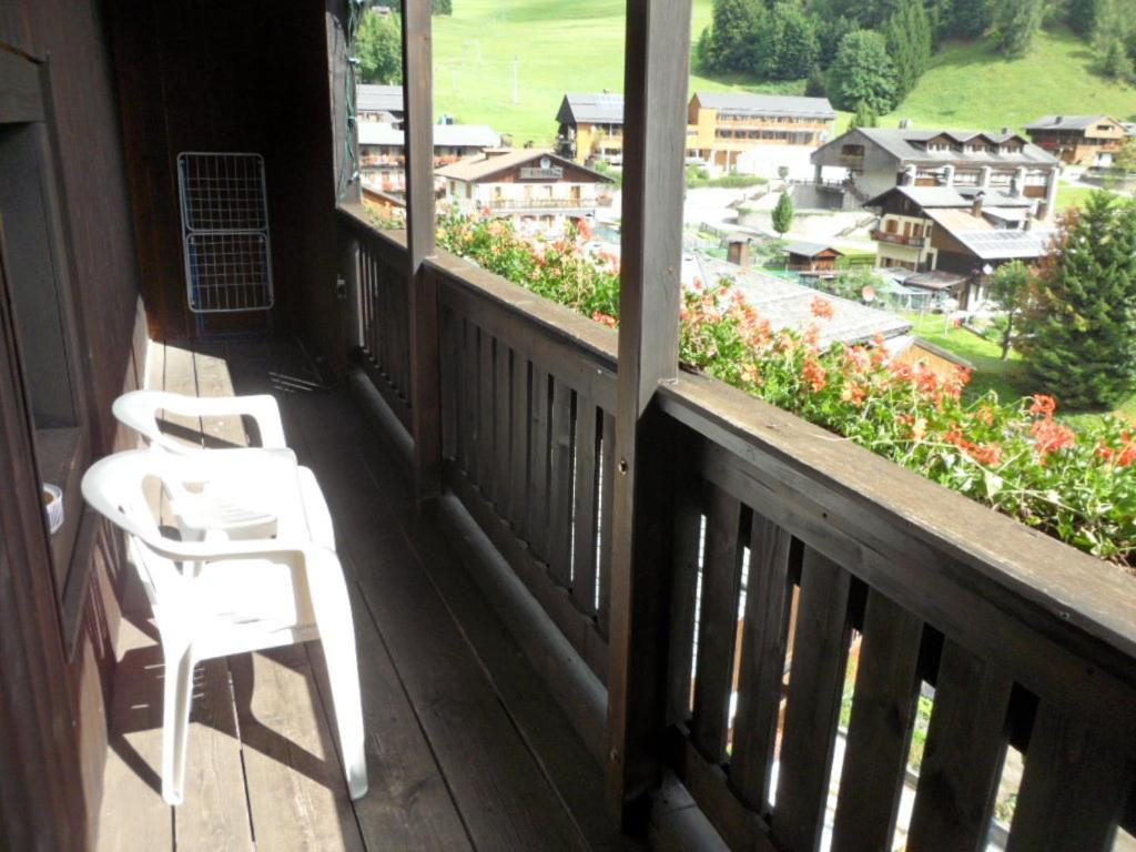 a porch with two chairs and a view of a town at Morgenleit in Sauris