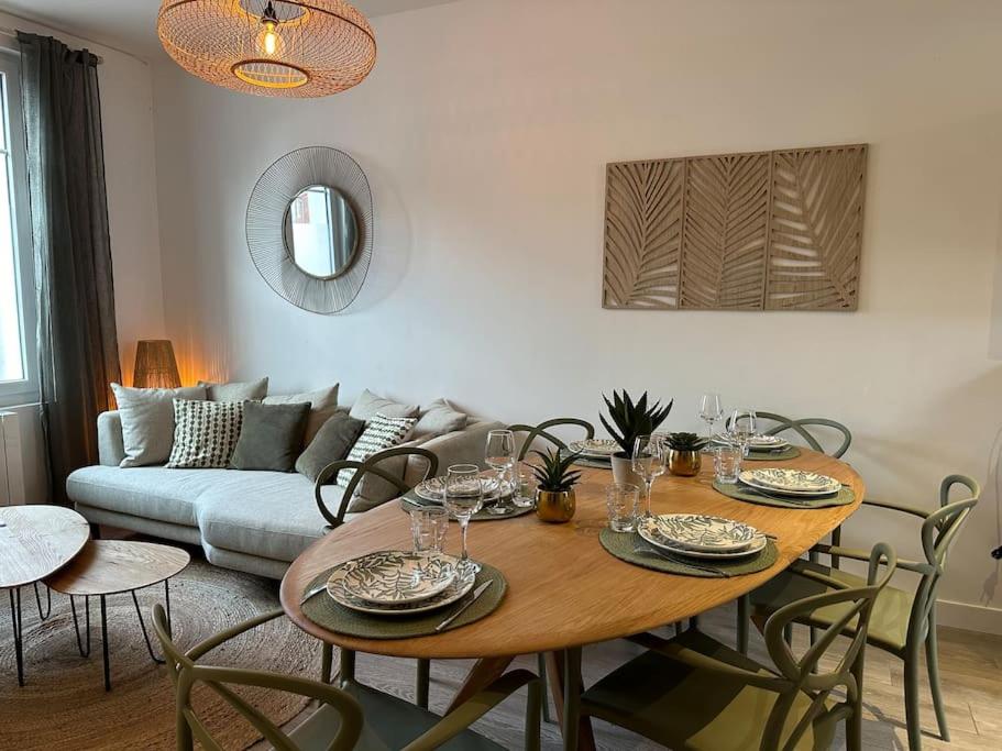 - un salon avec une table, des chaises et un canapé dans l'établissement « Maison Sauge » et son jardin, à Deauville