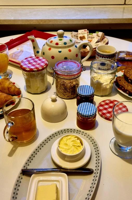 a table topped with jars and plates of food at City Farmers Lodge, a Guesthouse with a skyline view in Rural Amsterdam in Amsterdam
