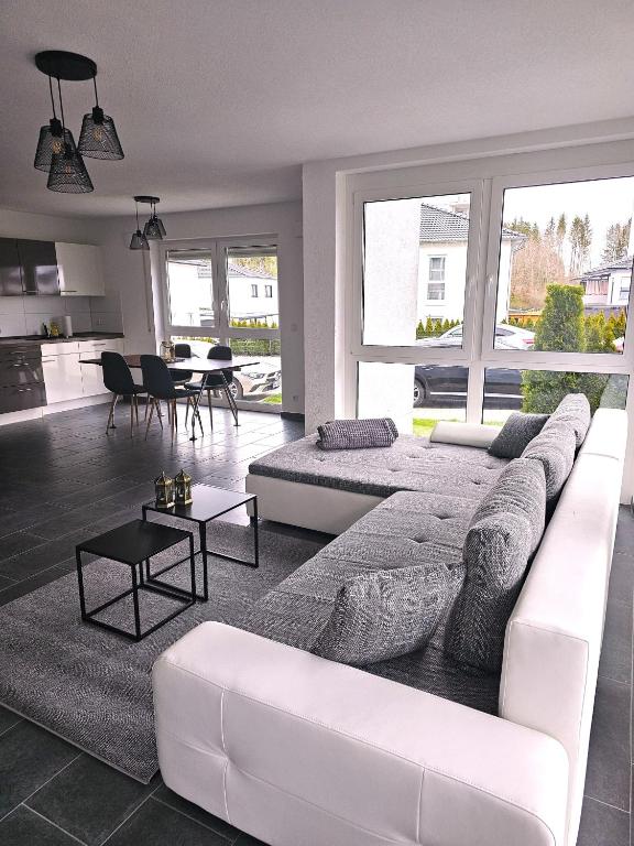 a living room with a white couch and a table at MY HOME N 35/1 in Villingen-Schwenningen