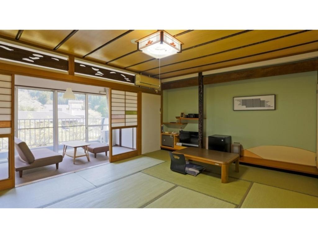 a living room with a tv and a table at Myoken Onsen Nemu - Vacation STAY 20867v in Kirishima