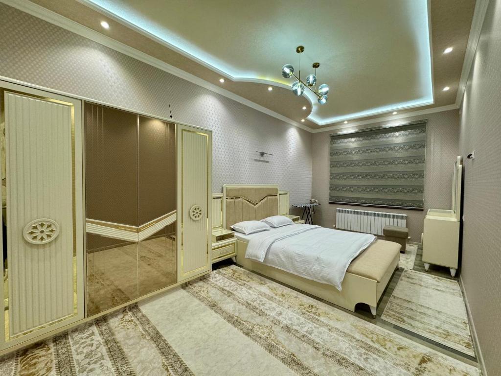 a bedroom with a bed and a walk in closet at Samarkand luxury apartament #8 in Samarkand