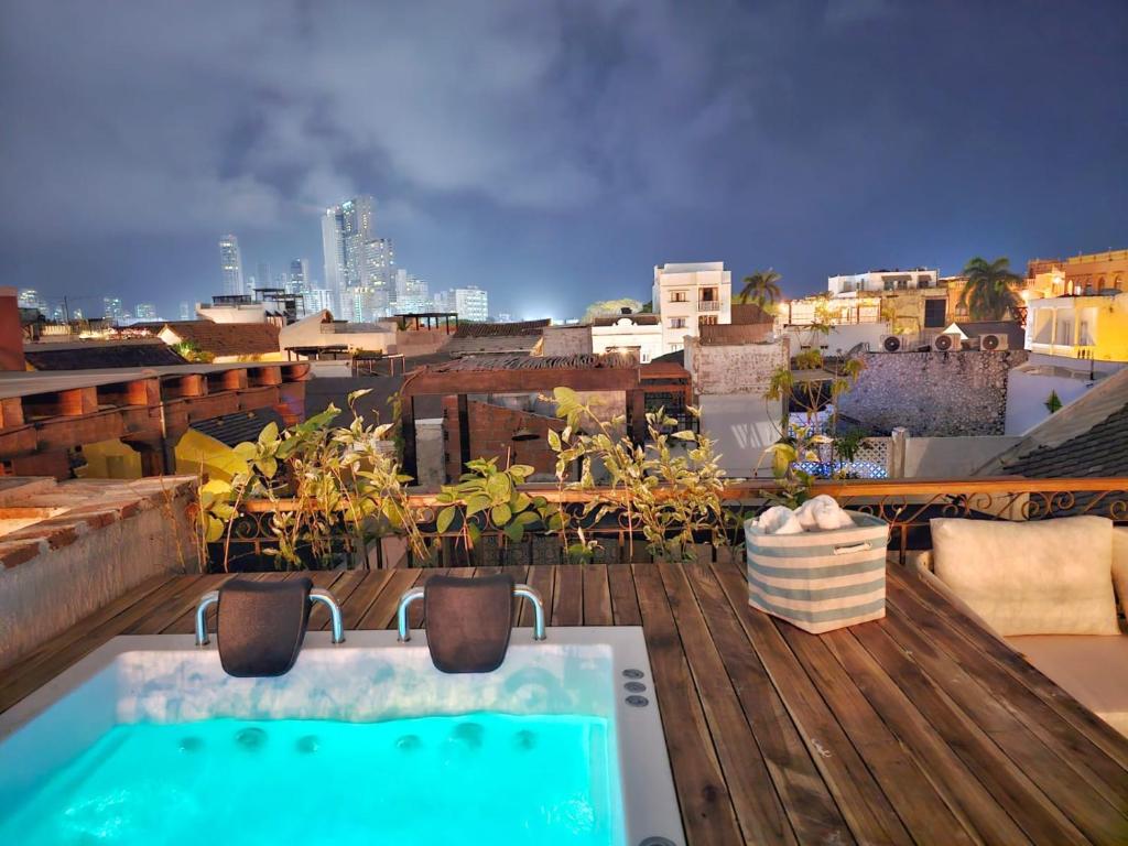 a bath tub sitting on top of a roof at Casa Coco 1680 Colonial & Art House In Old City - Pool - Jasussi - View in Cartagena de Indias