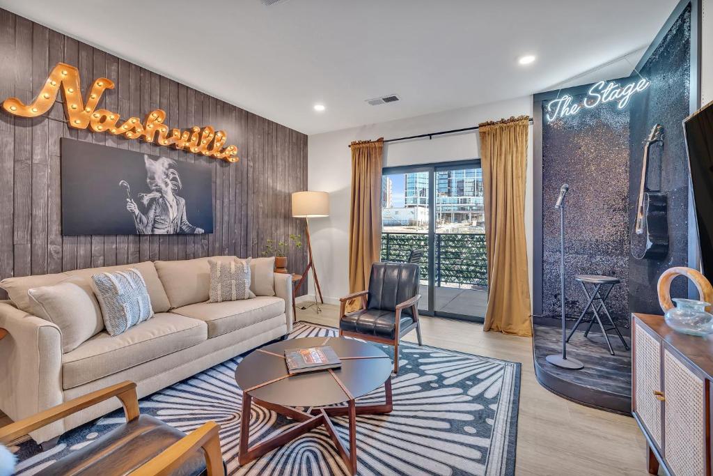 a living room with a couch and a table at The Stage in Downtown Nashville by Nautical Properties in Nashville