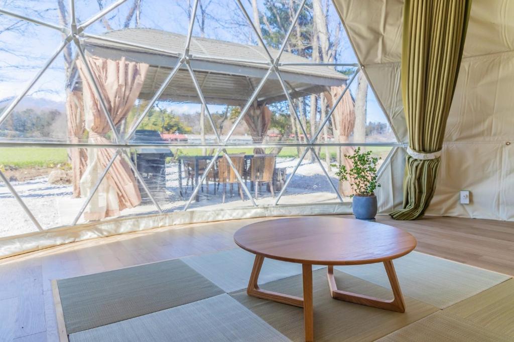 a room with a table and a large window at NAGOMI CAMP - Vacation STAY 48652v in Nasushiobara