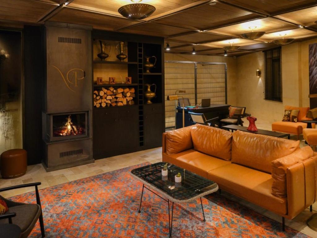 a living room with a couch and a fireplace at Very Peri Cappadocia - The Lifestyle Luxury Design Hotel in Uchisar