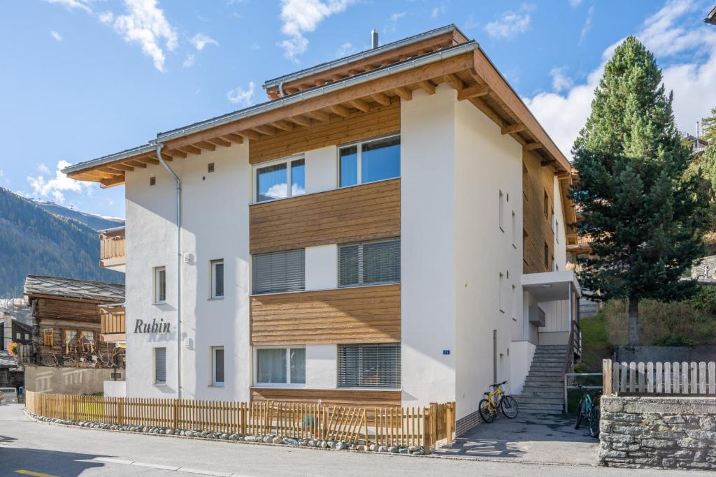 a apartment building with a wooden roof at Haus Rubin in Zermatt