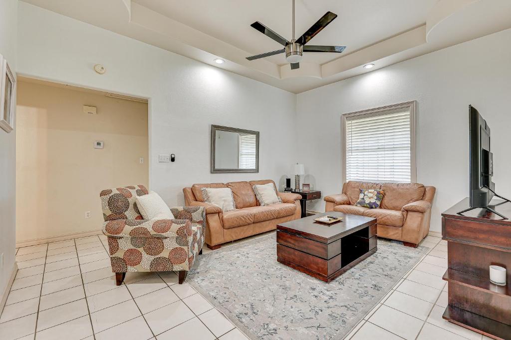 a living room with couches and a flat screen tv at Pet-Friendly San Juan Home with Private Yard and Grill in San Juan