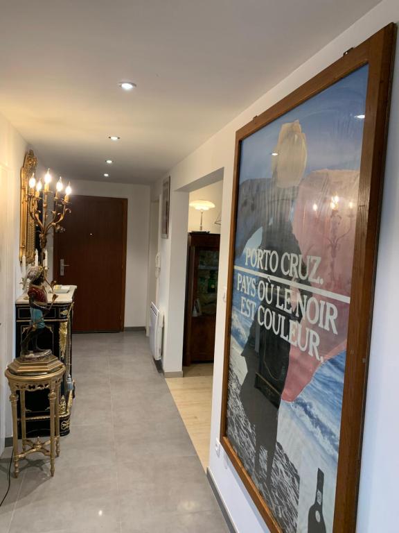 a hallway with a large poster on the wall at Appartement spacieux et lumineux in Sélestat