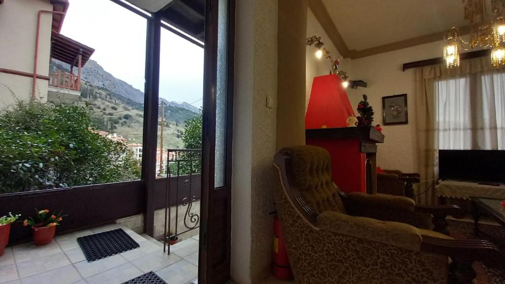 a living room with a view of a mountain at ΑΡΜΟΝΙΑ MountHome in Arachova