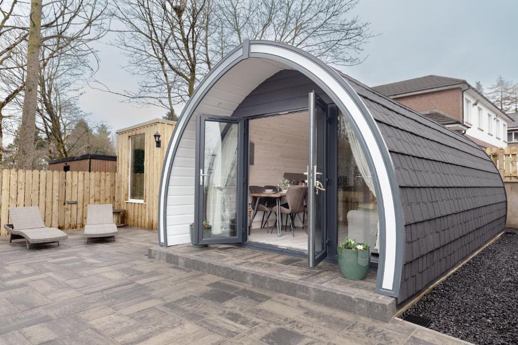 an arched aluminium extension to a house with a patio at Coolaness Glamping in Irvinestown