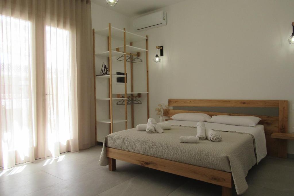 a bedroom with a bed with two towels on it at Broom House in San Foca