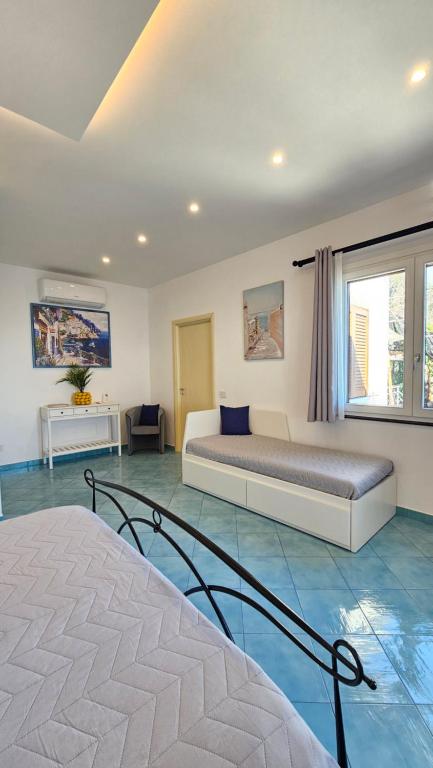 a bedroom with a bed and a large window at Villa Furoris Apartment in Furore