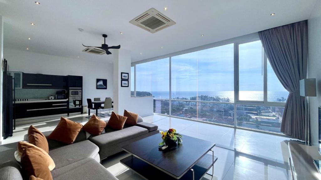 a living room with a couch and a table at A2-stunning Seaview 4brs3baths Duplex karon City in Ban Karon