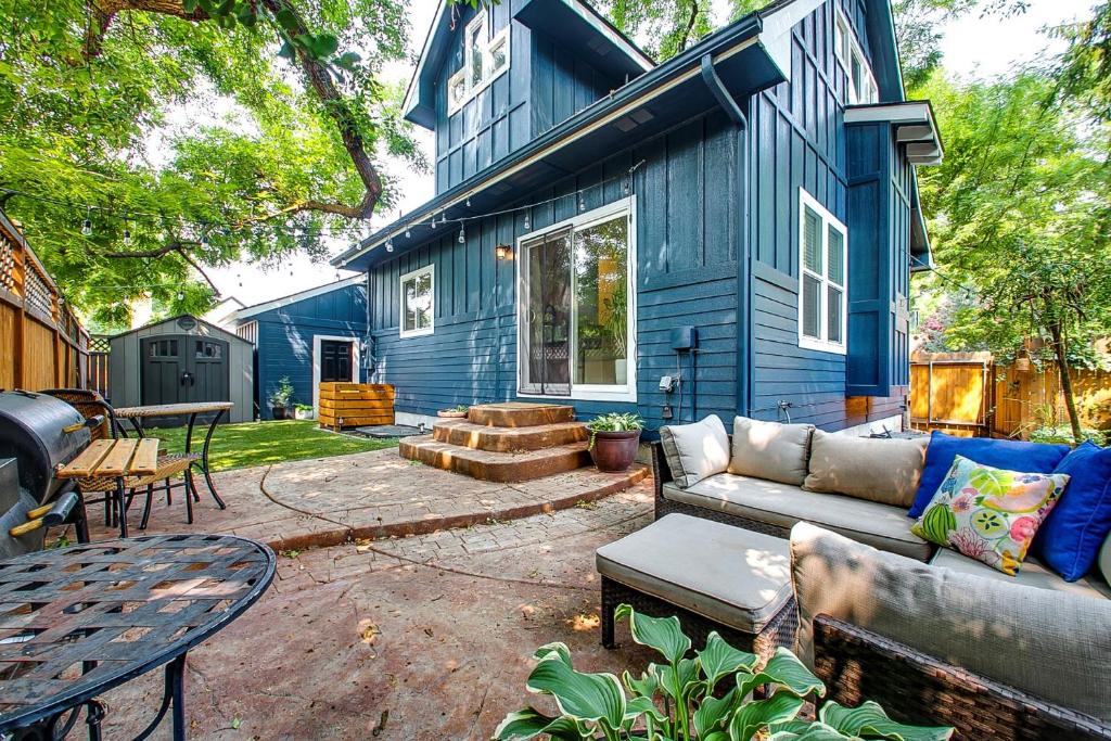 a blue house with a couch and a table at Blue Sky Bungalow in Boise