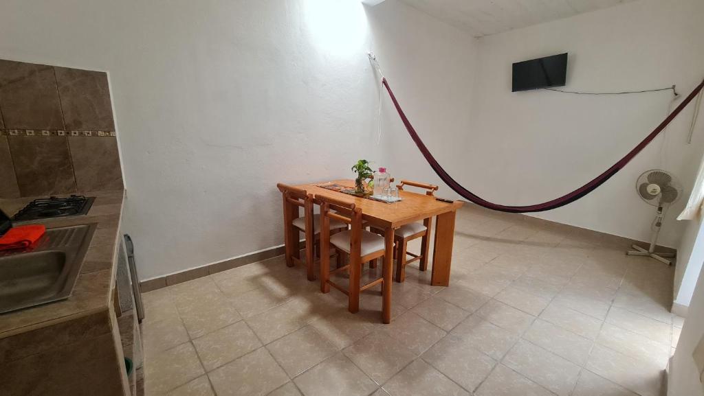 a small table in a kitchen with a hose at Departamento Añil in San Antonio de la Cal