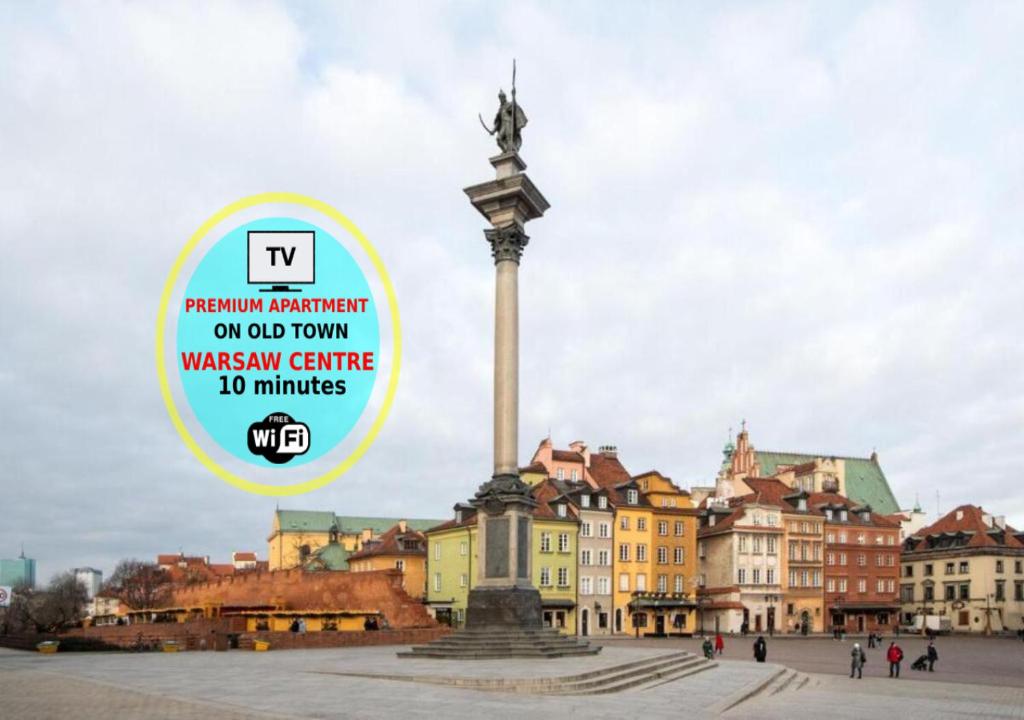 a monument in the middle of a city with a sign at Apartments Old Town by Arrenda in Warsaw