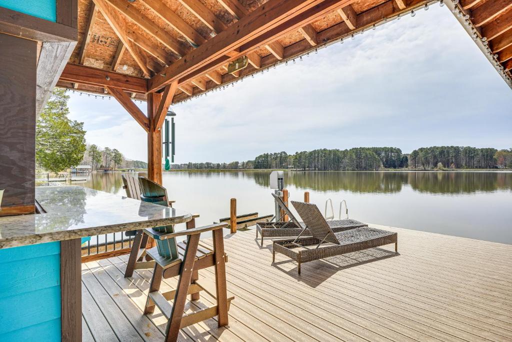 a dock with lounge chairs on a lake at Waterfront Lake Gaston Home with Private Dock! in Littleton