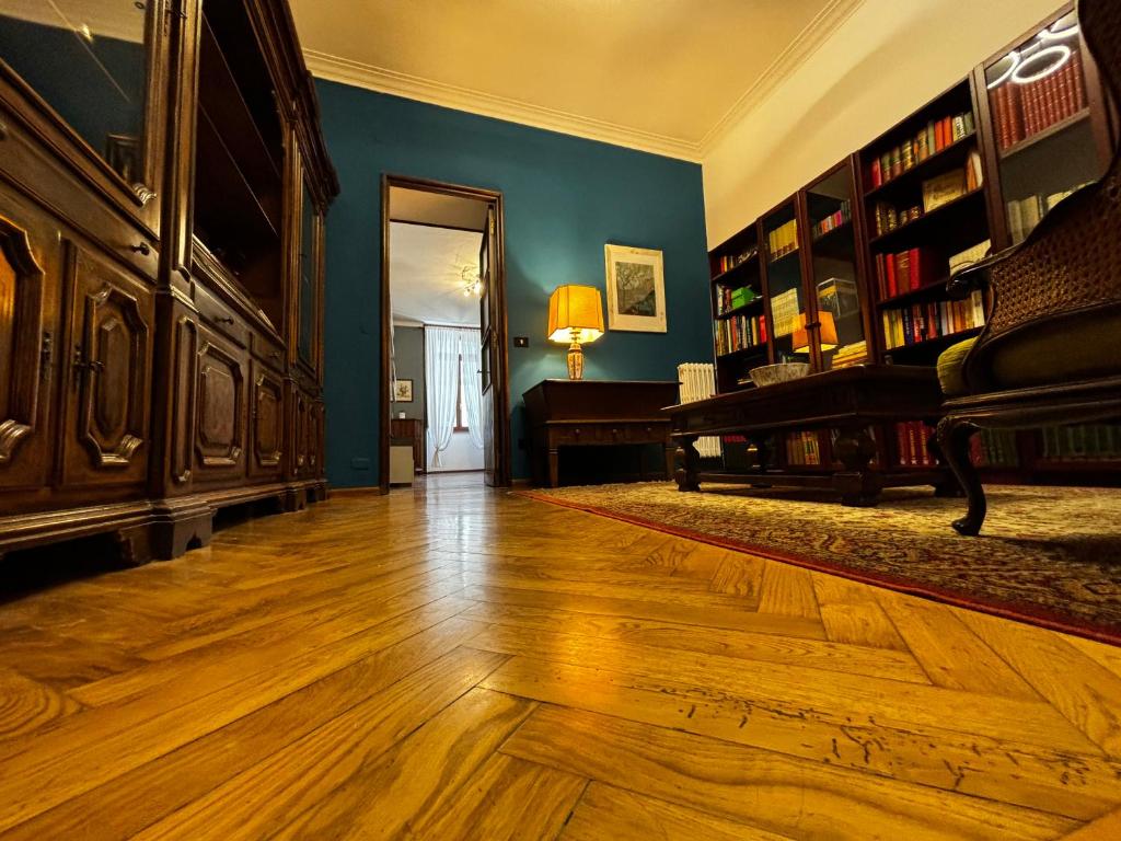 a living room with a hard wood floor and a piano at 3RDomus - Luxury suite con vista Duomo in Turin