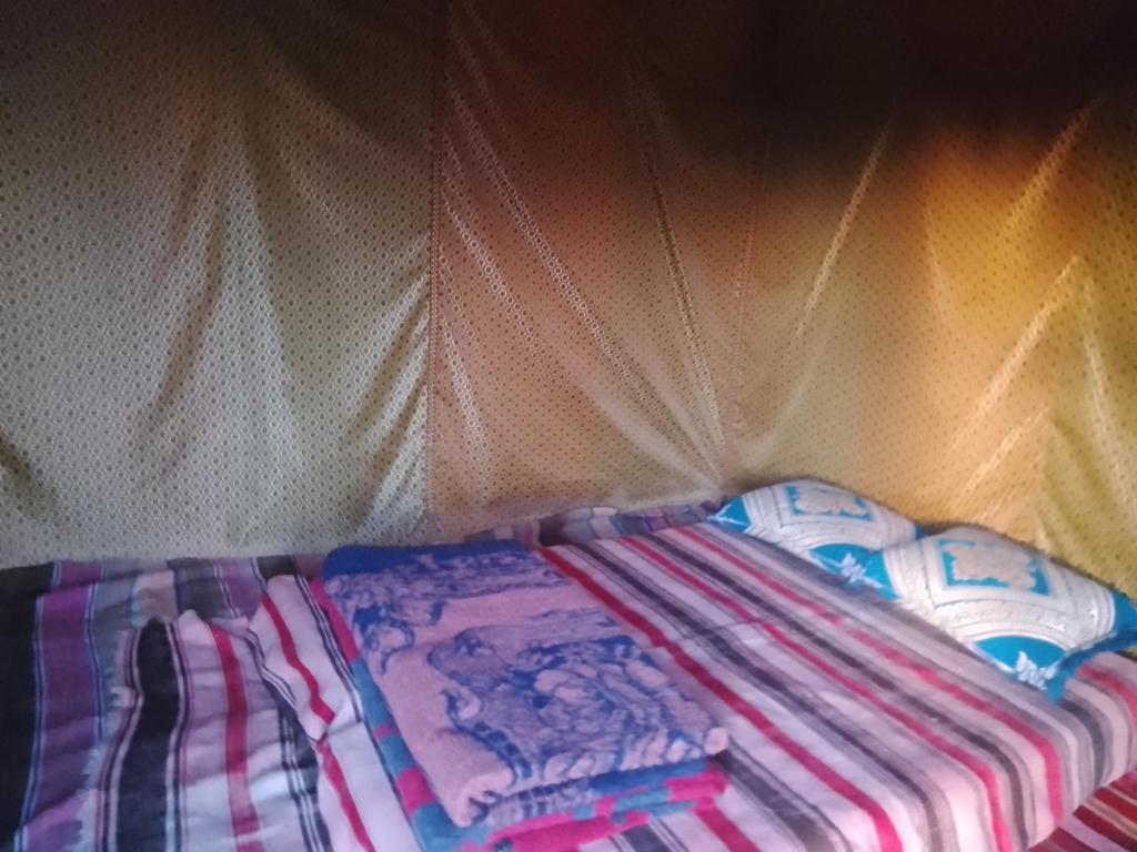 Un pat sau paturi într-o cameră la M'Hamid Budget Lodge