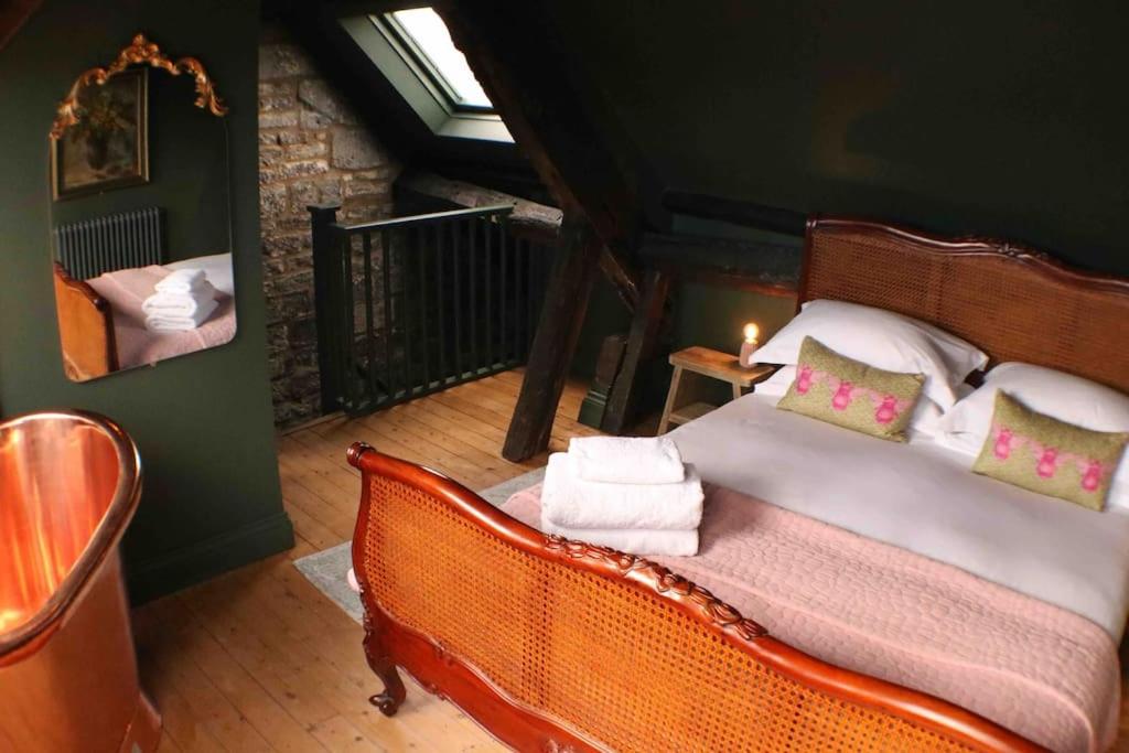 a bedroom with a bed in a room at The Old Forge in Cheltenham