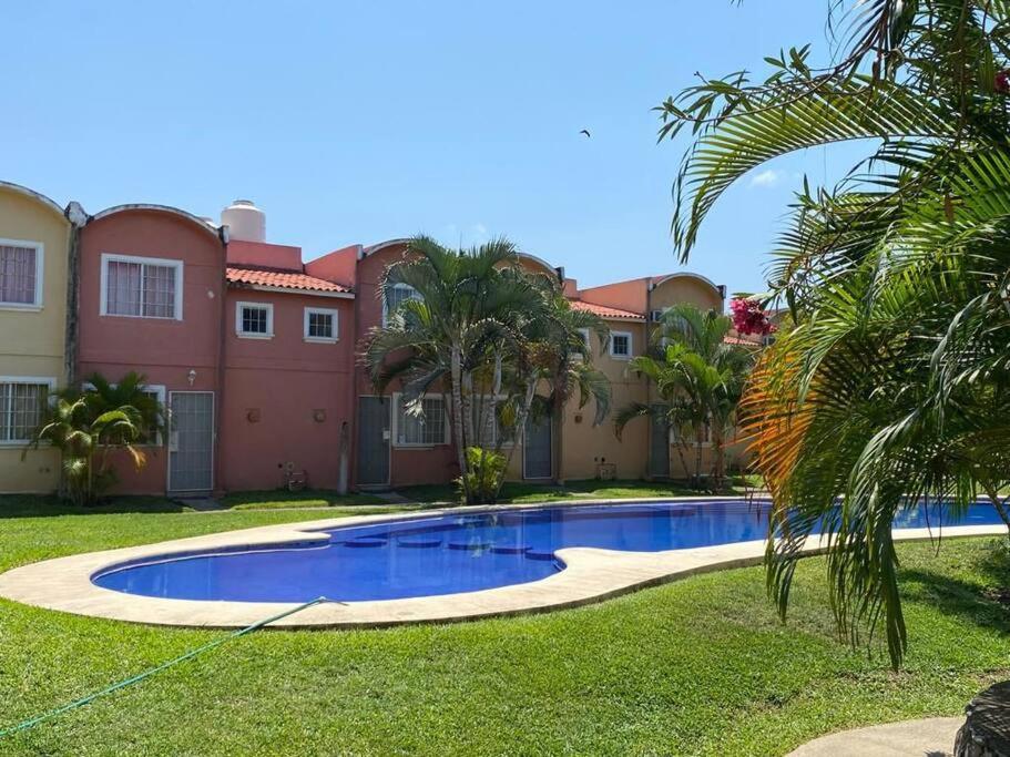 a swimming pool in the yard of a house at Casa para 8 personas in Zihuatanejo